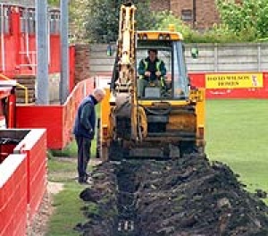 Barry Morton inspects a new drainage trench